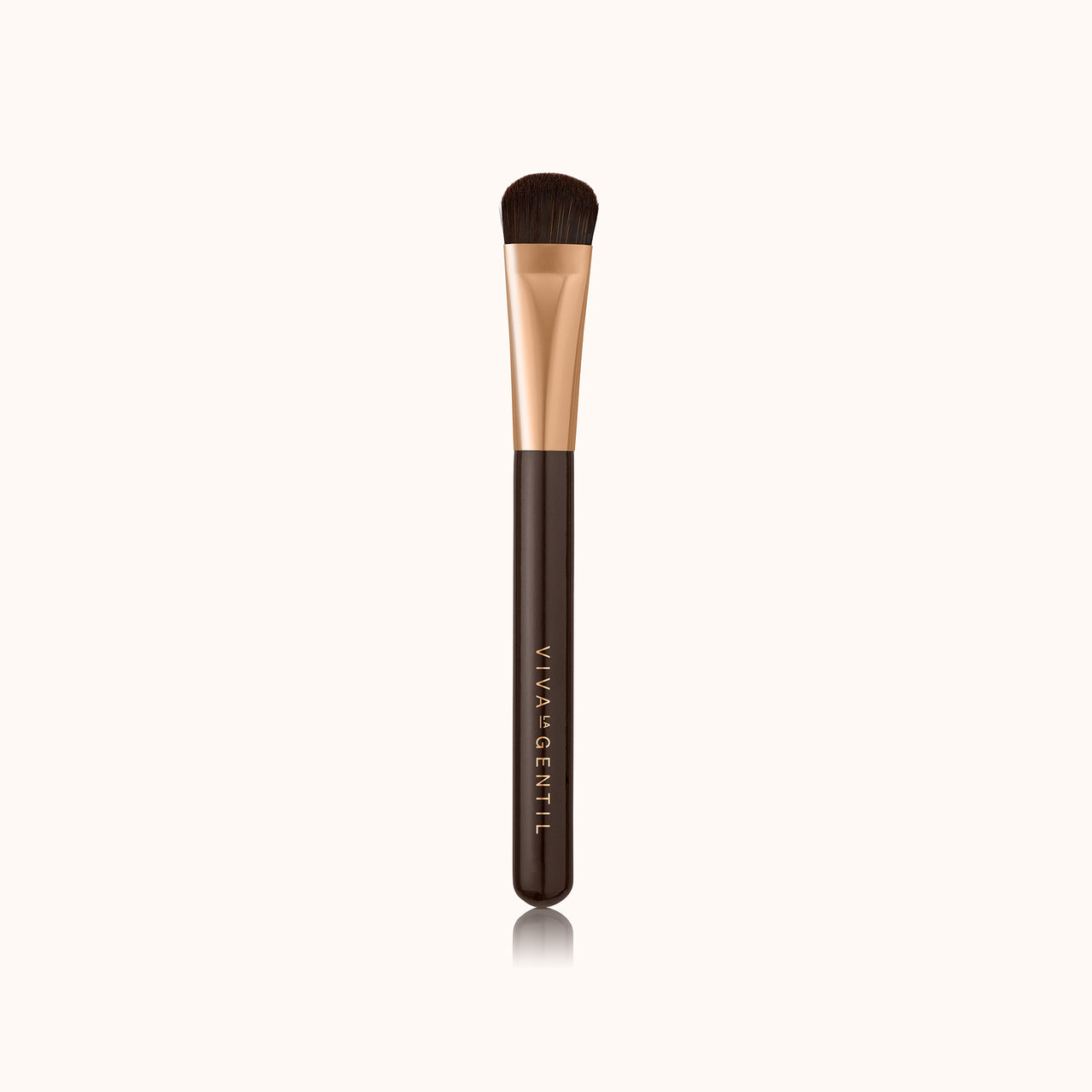 A soft curved thin makeup brush with a dark brown lacquered handle and a rose gold ferrule, made by mixing handmade synthetic dark brown bristles with a few strands of white bristles.